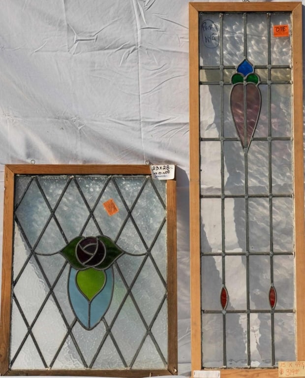 TWO ANTIQUE CONTINENTAL STAINED GLASS PANELS: Two antique Continental stained glass panels with floral motif central elements and colorless leaded glass panels. Approximate dimensions: h. 49.5", w. 15" Disclaimer: This is an online court ordered