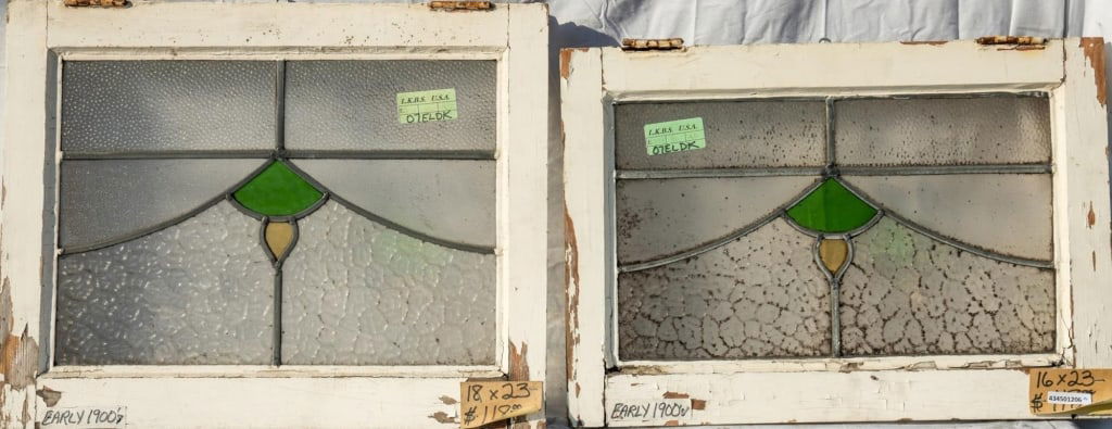 SET OF TWO CONTINENTAL STAINED GLASS PANELS: Set of two Continental stained glass panels with colorless textured leaded glass and amber and green accents. Approximate dimensions: h. 18", w. 23" Disclaimer: This is an online court ordered bankrup