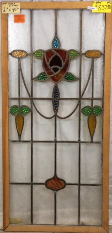 ENGLISH ART NOUVEAU STAINED GLASS PANEL: English Art Nouveau stained glass panel with floral medallion and two symmetrical floral elements to the sides. Approximate dimensions: h. 45", w. 21" Disclaimer: This is an online court ordered bankr