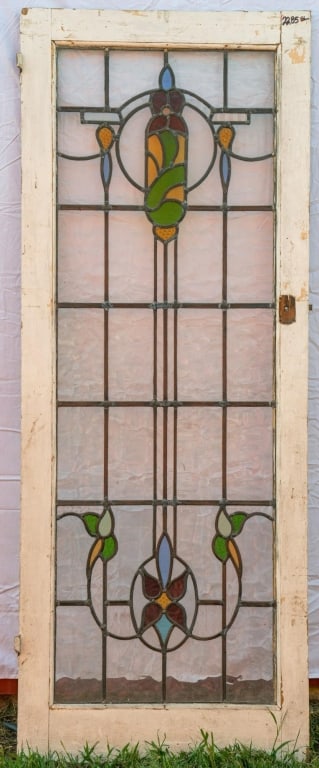 FRENCH ART NOUVEAU STAINED GLASS DOOR: French Art Nouveau stained glass door with a floral motif, and red, green, and yellow leaded glass details. Approximate dimensions: h. 76", w. 30" Disclaimer: This is an online court ordered bankruptc