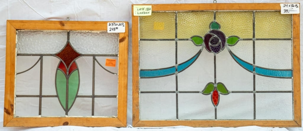 TWO FRENCH ART NOUVEAU STAINED GLASS PANELS: Two French Art Nouveau stained glass panels with floral and ribbon motif and abstract geometric motif. Approximate dimensions: h. 24", w. 32.5" Disclaimer: This is an online court ordered bankruptcy s