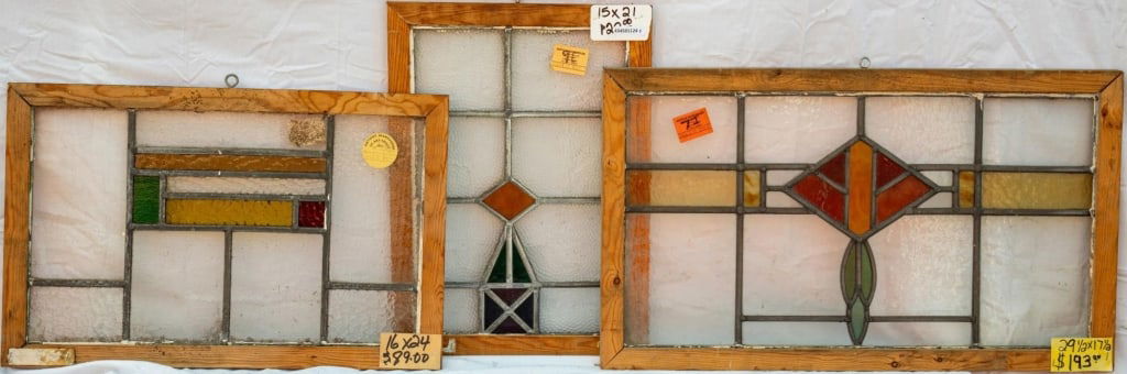THREE FRENCH STAINED GLASS PANELS: Three French stained glass panels with geometric stained glass elements, wispy glass and textured accents. Approximate dimensions: h. 17.5", w. 29.5" Disclaimer: This is an online court ordered bankru