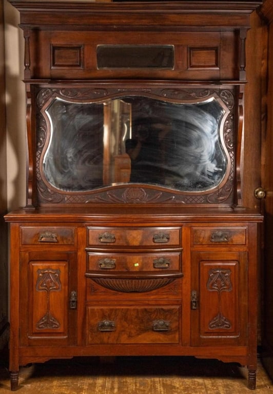 FRENCH ART NOUVEAU MAHOGANY BUFFET: French Art Nouveau mahogany buffet with beveled mirror, carved supports, inset carved panels, and brass pulls. Approximate dimensions: h. 83", w. 55", d. 18" Disclaimer: This is an online court ordere