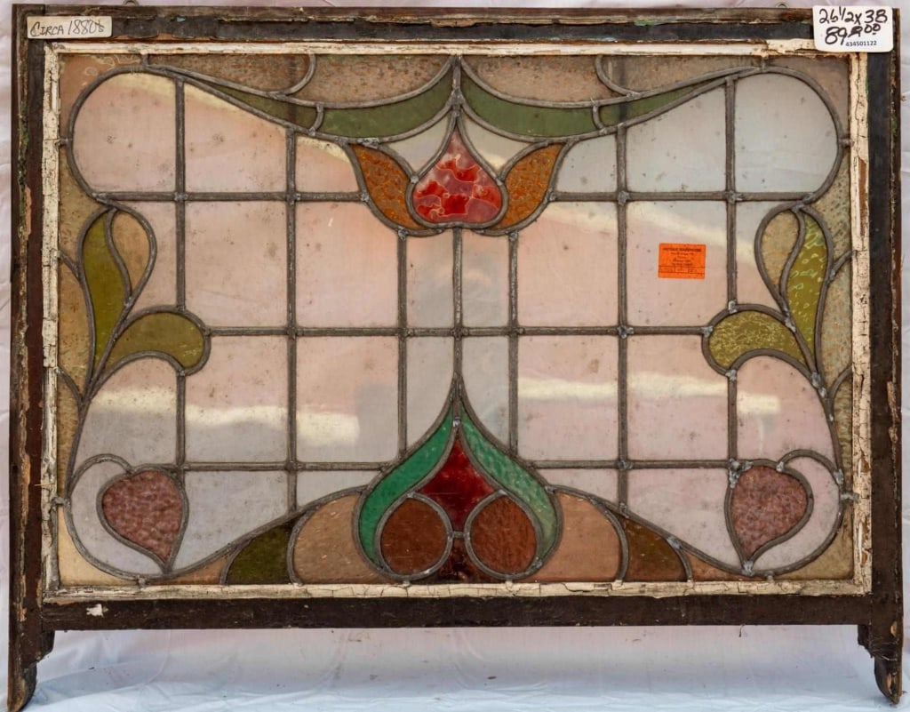 FRENCH ART NOUVEAU STAINED GLASS PANEL: French Art Nouveau stained glass panel with a floral and botanical motif. Approximate dimensions: h. 26.5", w. 38" Disclaimer: This is an online court ordered bankruptcy sale. Participating bidders mu