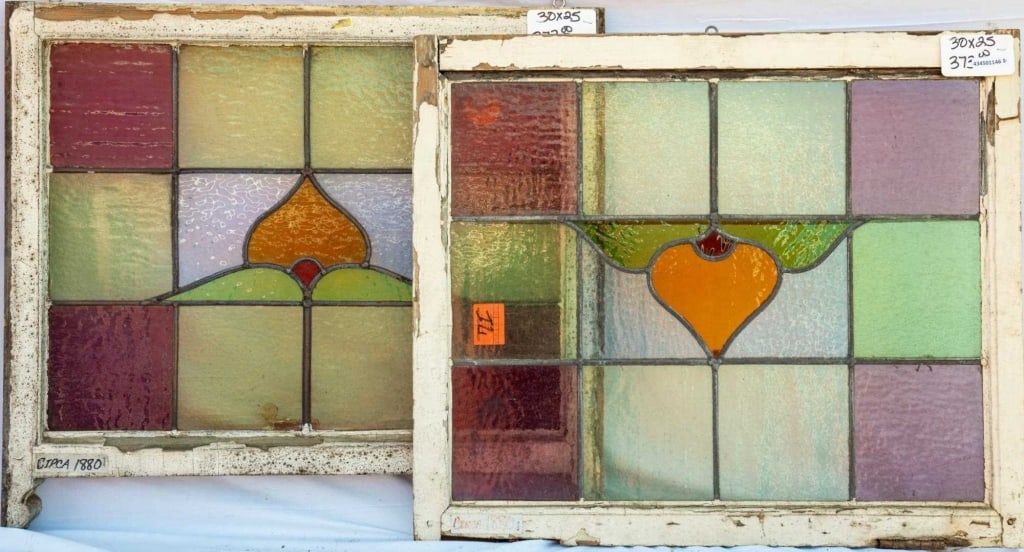 PAIR OF FRENCH STAINED GLASS PANELS: Pair of French stained glass panels with floral motif, and square green and purple leaded glass panels. Approximate dimensions: h. 25", w. 30" Disclaimer: This is an online court ordered bankruptcy sa