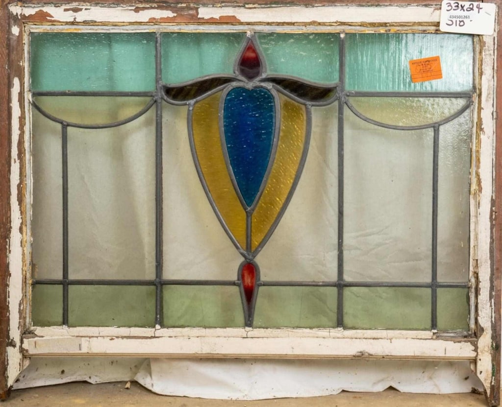 FRENCH ART NOUVEAU STAINED GLASS PANEL: French Art Nouveau stained glass panel with a floral motif, heart-shaped central medallion, and red wispy glass accent. Approximate dimensions: h.24", w. 33" Disclaimer: This is an online court ordere