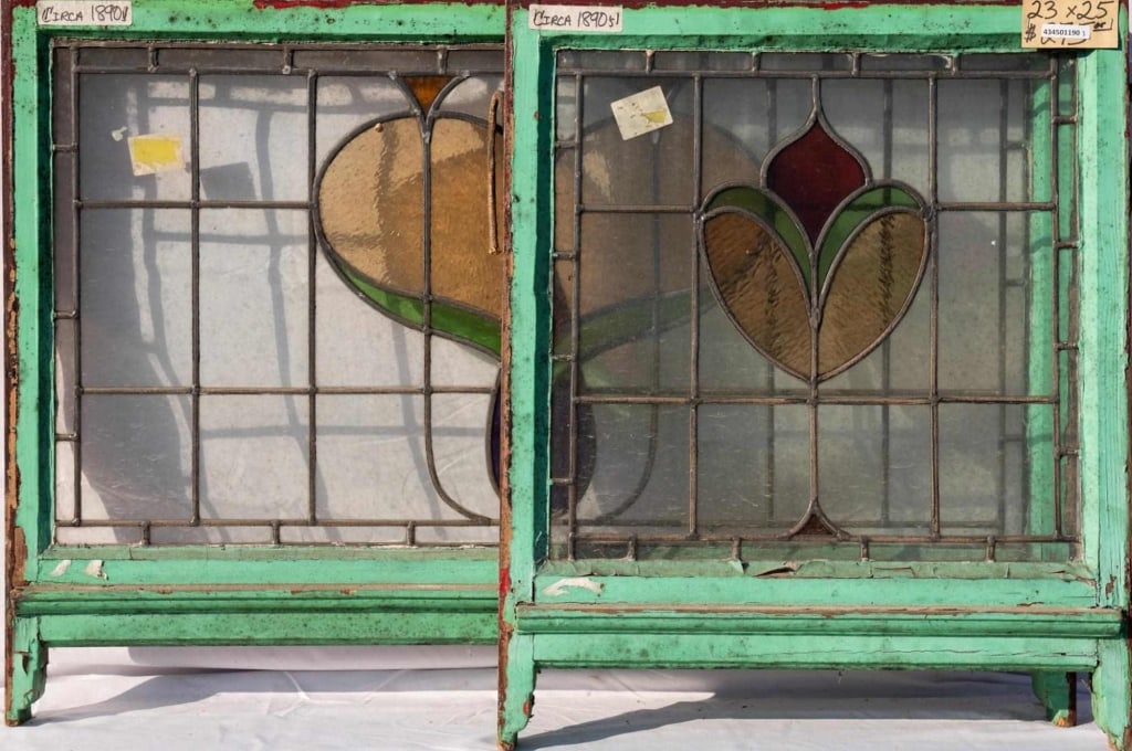 TWO FRENCH ART NOUVEAU STAINED GLASS PANELS: Two French Art Nouveau stained glass panels with floral medallions in purple, red, green, and amber. Approximate dimensions: h. 25", w. 41" Disclaimer: This is an online court ordered bankruptcy sale.