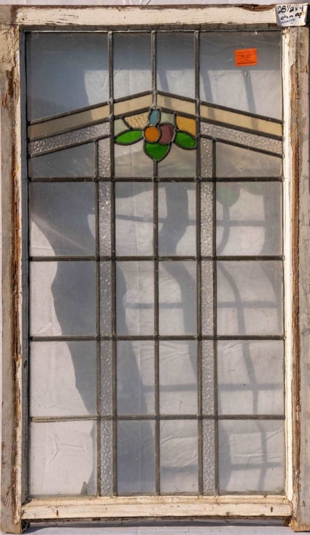 FRENCH ART NOUVEAU STAINED GLASS PANEL: French Art Nouveau stained glass panel with a floral medallion and colorless textured and amber leaded glass panels. Approximate dimensions: h. 47", w. 28.5" Disclaimer: This is an online court ordere