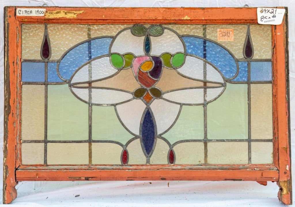 FRENCH ART NOUVEAU STAINED GLASS PANEL: French Art Nouveau stained glass panel with floral medallion set within multicolored textured leaded glass panels. Approximate dimensions: h. 21", w. 34" Disclaimer: This is an online court ordered ba