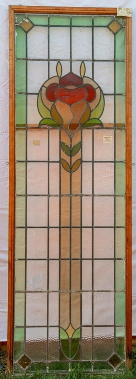 MONUMENTAL FRENCH ART NOUVEAU STAINED GLASS DOOR: Monumental French Art Nouveau stained glass door with a floral pattern and emerald green and red leaded glass accents. Approximate dimensions: h. 84", w. 28" Disclaimer: This is an online court ordere