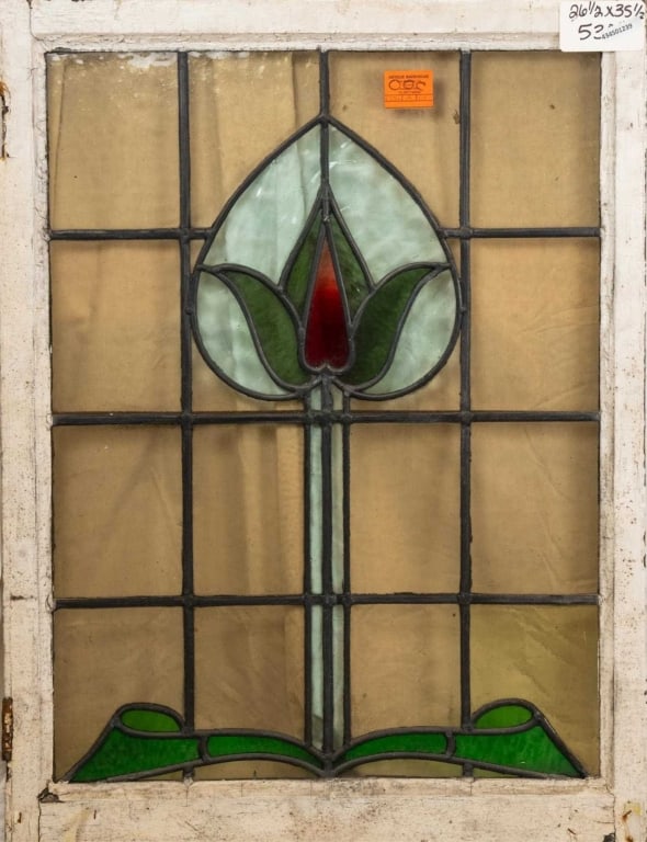 FRENCH ART NOUVEAU STAINED GLASS PANEL: French Art Nouveau stained glass panel with a heart-shaped floral motif medallion and a green garland accent at the bottom. Approximate dimensions: h. 35.5", w. 26.5" Disclaimer: This is an online cou