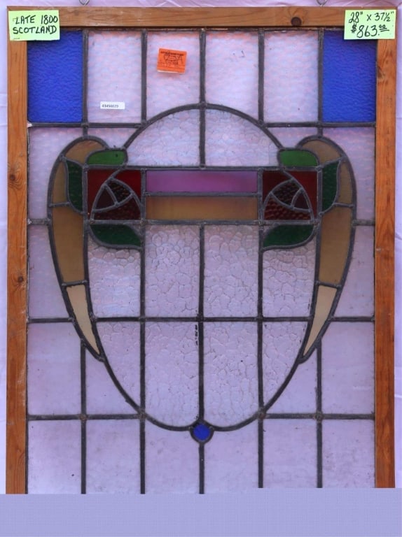 ANTIQUE STAINED GLASS WINDOW: Antique stained glass window. Approximate dimensions: h. 28", w. 37.5" Disclaimer: This is an online court ordered bankruptcy sale. Participating bidders must have a credit card on file with Live Auct