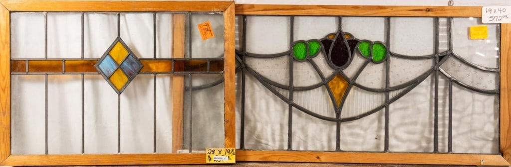 TWO CONTINENTAL STAINED GLASS PANELS: Two Continental stained glass panels, one with wispy glass accents and the other with a floral medallion. Approximate dimensions: h. 19", w. 40" Disclaimer: This is an online court ordered bankruptcy