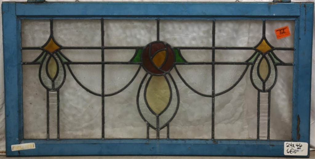 FRENCH ART NOUVEAU STAINED GLASS PANEL: French Art Nouveau stained glass panel with central rose motif and two symmetrical drop and rhombic accents to the sides. Approximate dimensions: h. 24", w. 46" Disclaimer: This is an online court ord