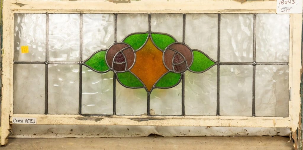 FRENCH ART NOUVEAU STAINED GLASS PANEL: French Art Nouveau stained glass panel, showcasing a double rose medallion with leaves and amber glass accents. Approximate dimensions: h. 18", w. 43" Disclaimer: This is an online court ordered bankr