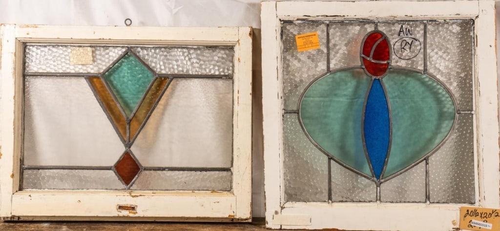 TWO CONTINENTAL STAINED GLASS PANELS: Two Continental stained glass panels, one Art Deco with a geometric medallion and the other Art Nouveau with a heart-shaped medallion. Approximate dimensions: h. 20.5", w. 20.5" Disclaimer: This is an