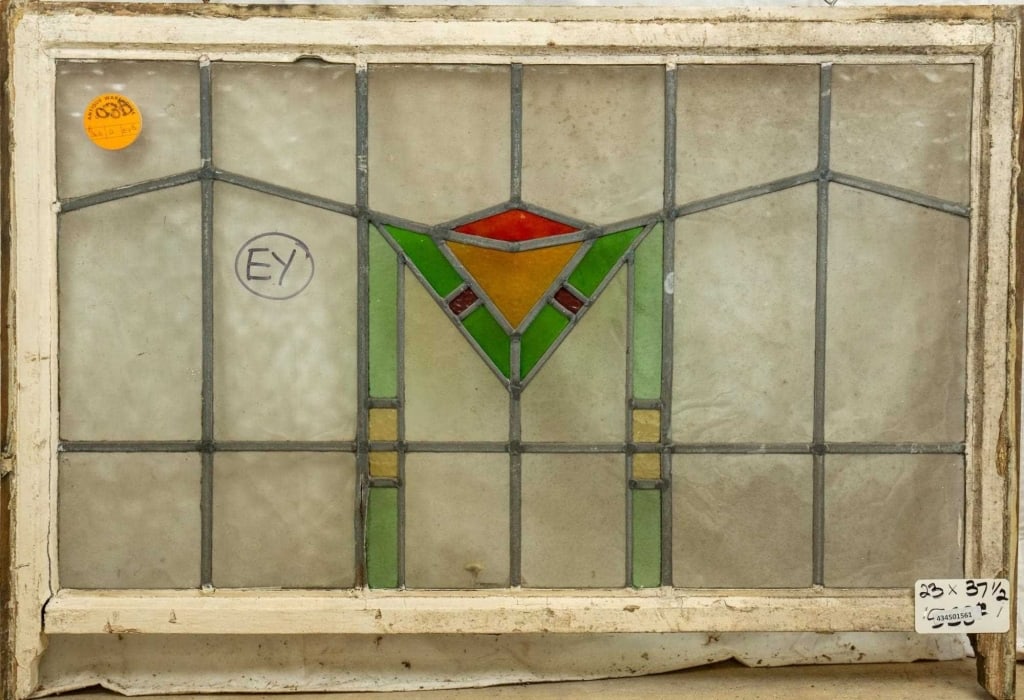 ENGLISH ART DECO STAINED GLASS PANEL: English Art Deco stained glass panel with geometrical multicolored medallion. Approximate dimensions: h. 23", w. 37.5" Disclaimer: This is an online court ordered bankruptcy sale. Participating bidder