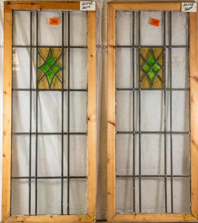 PAIR OF ENGLISH STAINED GLASS PANELS: Pair of English stained glass panels with amber and green medallions and colorless leaded glass panels. Approximate dimensions: h. 48", w. 20" Disclaimer: This is an online court ordered bankruptcy sa
