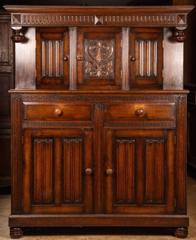 ENGLISH OAK COURT CUPBOARD: English oak court cupboard with carved fold-on inset panels and bun feet. Approximate dimensions: h. 61", w. 48", d. 18" Disclaimer: This is an online court ordered bankruptcy sale. Participating bidd