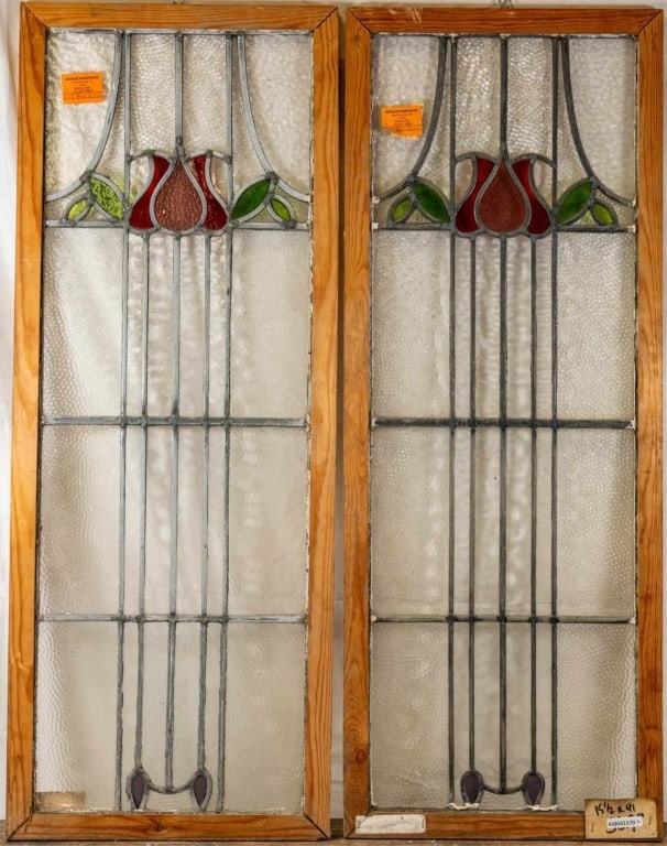 PAIR OF FRENCH ART NOUVEAU STAINED GLASS PANELS: Pair of French Art Nouveau stained glass panels with rose and leaf medallions and colorless leaded glass panels. Approximate dimensions: h. 41", w. 15.5" Disclaimer: This is an online court ordered ba