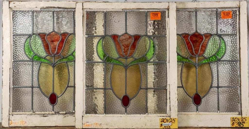 THREE FRENCH ART NOUVEAU STAINED GLASS PANELS: Three French Art Nouveau stained glass panels with floral medallion and amber and red accents. Approximate dimensions: h. 25", w. 20" Disclaimer: This is an online court ordered bankruptcy sale. Parti