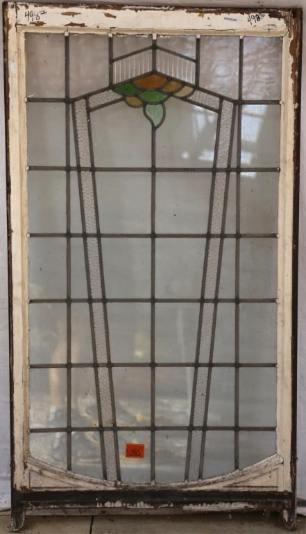 ENGLISH ART DECO STAINED GLASS PANEL: English Art Deco stained glass panel with amber, green, and yellow stained glass geometric elements, some colorless panels are textured. Approximate dimensions: h. 56", w. 32" Disclaimer: This is an o