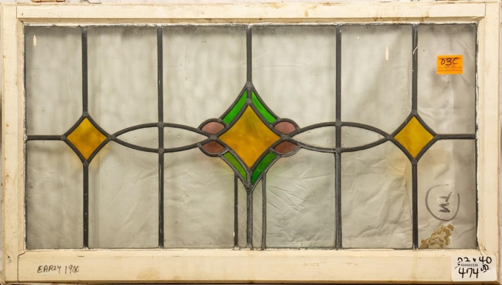 CONTINENTAL STAINED GLASS PANEL: Continental stained glass panel with rhombic multicolored glass elements. Approximate dimensions: h. 22", w. 40" Disclaimer: This is an online court ordered bankruptcy sale. Participating bidders must