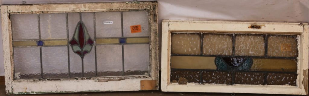 TWO ANTIQUE ENGLISH STAINED GLASS PANELS: Two antique English stained glass panels with geometric multicolored medallions and colorless textured leaded glass. Approximate dimensions: h. 18", w. 30" Disclaimer: This is an online court ordered