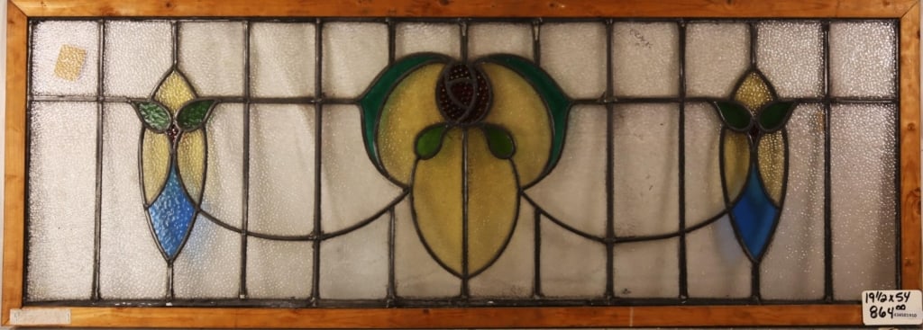 FRENCH ART NOUVEAU STAINED GLASS PANEL: French Art Nouveau stained glass panel with central floral medallion and symmetrical floral accents to the sides. Approximate dimensions: h. 19.5", w. 54" Disclaimer: This is an online court ordered b