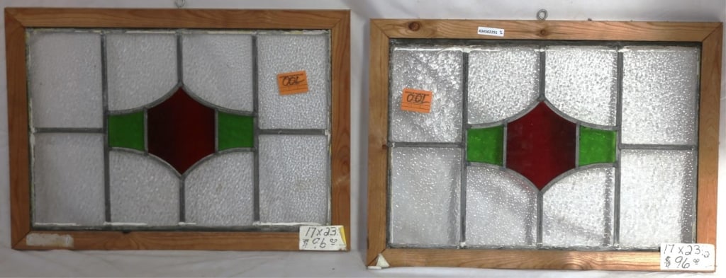 PAIR OF ANTIQUE IRISH STAINED GLASS PANELS: Pair of antique Irish stained glass panels with red and green geometric motif medallions and colorless leaded glass panels. Approximate dimensions: h. 17", w. 23.5" Disclaimer: This is an online court