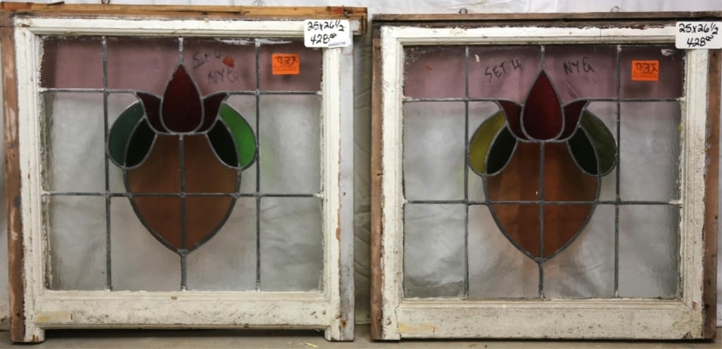 PAIR OF FRENCH ART NOUVEAU STAINED GLASS PANELS: Pair of French Art Nouveau stained glass panels with red flower, leaves, and amber heart medallion. Approximate dimensions: h. 25", w. 26.5 Disclaimer: This is an online court ordered bankruptcy sale.