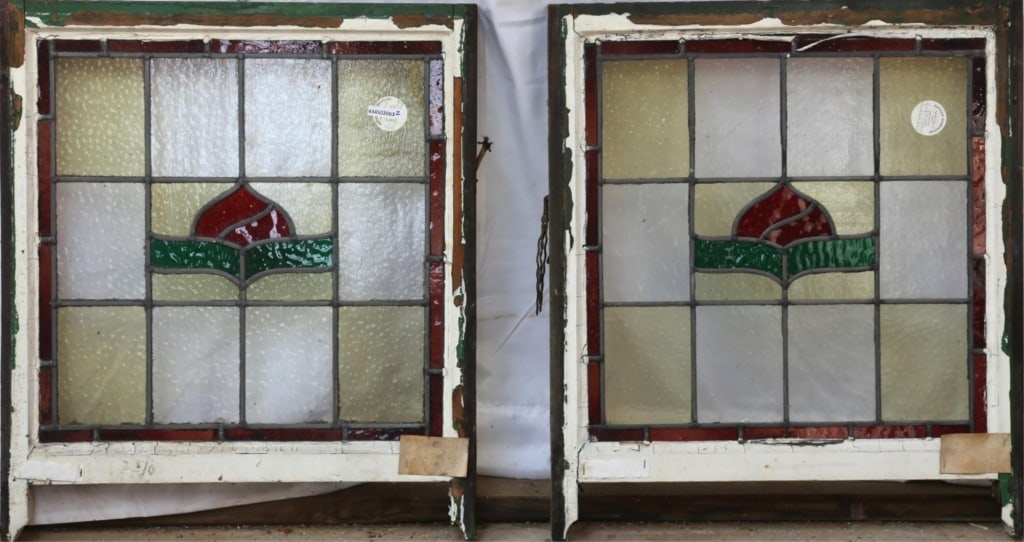 PAIR OF ANTIQUE ENGLISH STAINED GLASS PANELS: Pair of antique English stained glass panels with floral motif and yellow and colorless leaded glass panels. Approximate dimensions: h. 23.5", w. 25" Disclaimer: This is an online court ordered bankru
