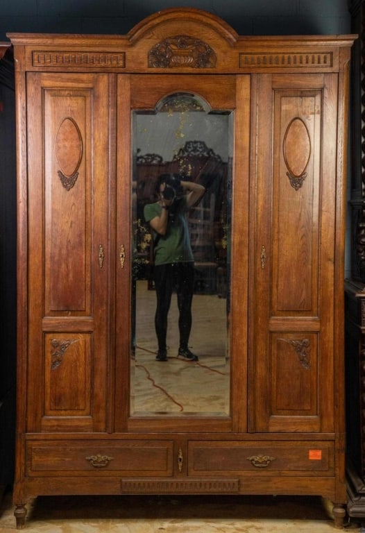 FRENCH ART NOUVEAU MIRRORED ARMOIRE: French Art Nouveau mirrored armoire with basket carving, parquetry, turned feet, and beveled mirror. Approximate dimensions: h. 86", w. 58", d. 23.5" Disclaimer: This is an online court ordered bankru