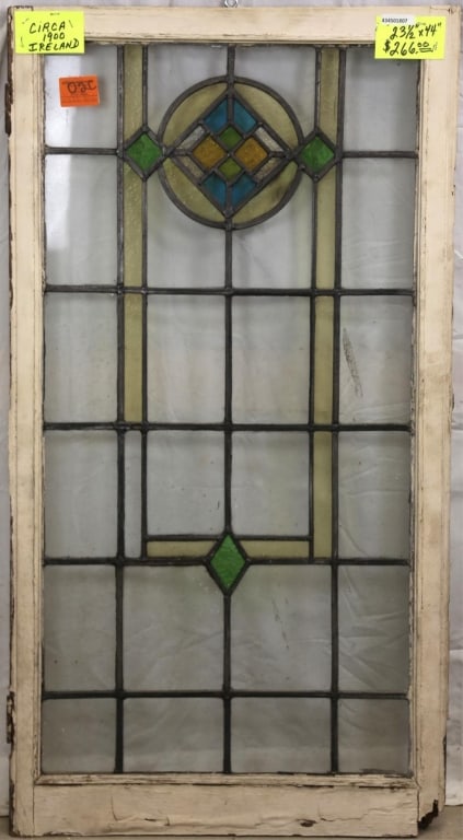 IRISH ART DECO STAINED GLASS PANEL: Irish Art Deco stained glass panel with multicolored geometric medallion. Approximate dimensions: h. 44", w. 23.5" Disclaimer: This is an online court ordered bankruptcy sale. Participating bidders mu