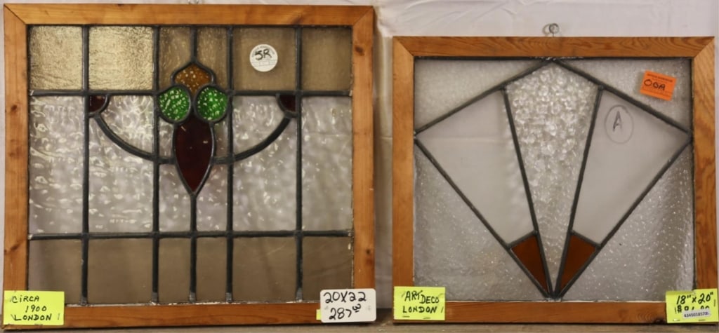 TWO ANTIQUE ENGLISH STAINED GLASS PANELS: Two antique English stained glass panels, one with floral medallion and the other with geometric Art Deco design. Approximate dimensions: h. 20", w. 22" Disclaimer: This is an online court ordered ban