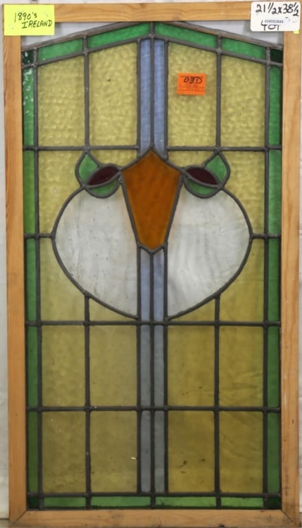 ANTIQUE IRISH STAINED GLASS PANEL: Antique Irish stained glass panel with shield-form medallion and two floral elements at the sides. Approximate dimensions: h. 38.5", w. 21.5" Disclaimer: This is an online court ordered bankruptcy sal