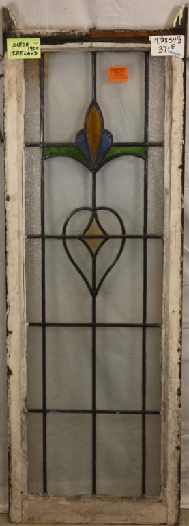 ANTIQUE IRISH STAINED GLASS PANEL: Antique Irish stained glass panel with amber, green, and blue stained glass details and textured colorless leaded glass panels. Approximate dimensions: h. 54.5", w. 19.5" Disclaimer: This is an online