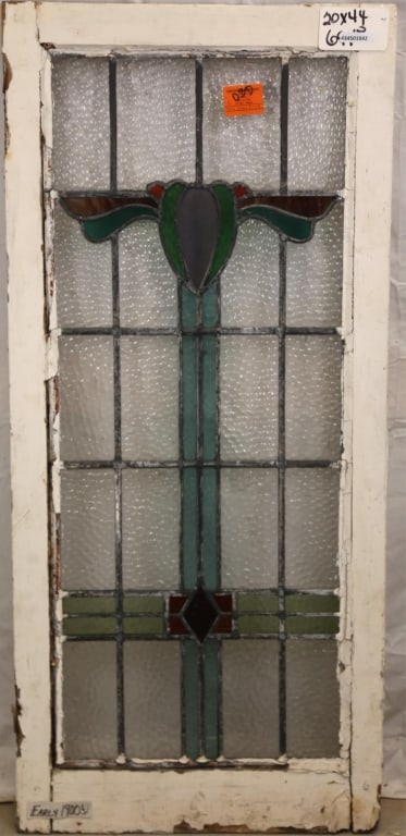 FRENCH ART DECO STAINED GLASS PANEL: French Art Deco stained glass panel with heart-shaped medallion, geometric stained glass accents, and wispy glass details. Approximate dimensions: h. 44", w. 20" Disclaimer: This is an online court or