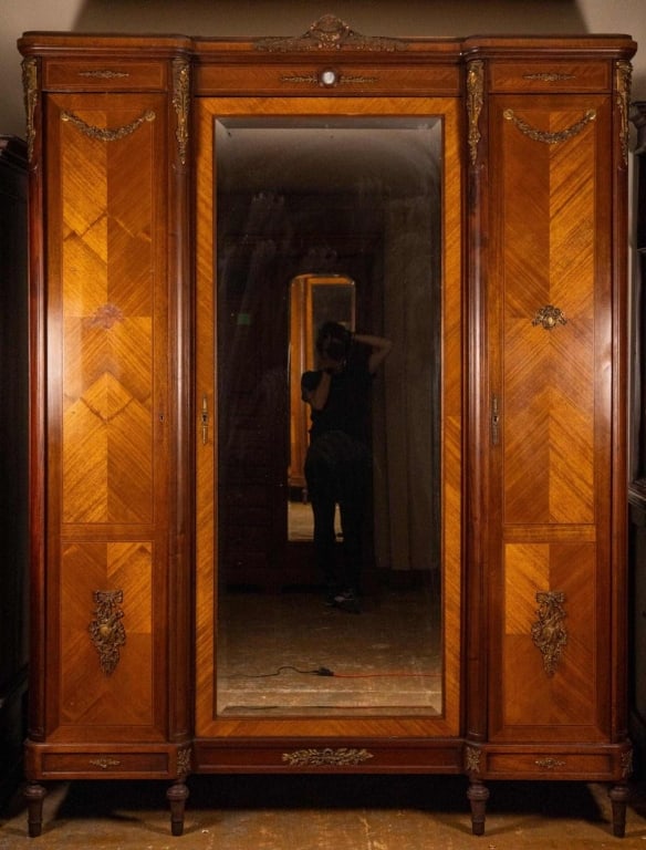19TH C. FRENCH PARQUETRY INLAID ARMOIRE: French, 19th century. Parquetry inlaid armoire with bronze mounts, porcelain putti inset, carved legs, and beveled mirror. Approximate dimensions: h. 90", w. 68", d. 21" Disclaimer: This is an online 