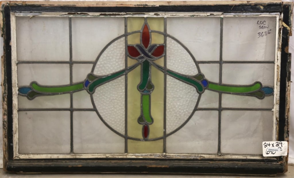 FRENCH ART NOUVEAU STAINED GLASS PANEL: French Art Nouveau stained glass panel with floral medallion and symmetrical botanical motif with green and blue details to the sides. Approximate dimensions: h. 24", w. 39" Disclaimer: This is an onl