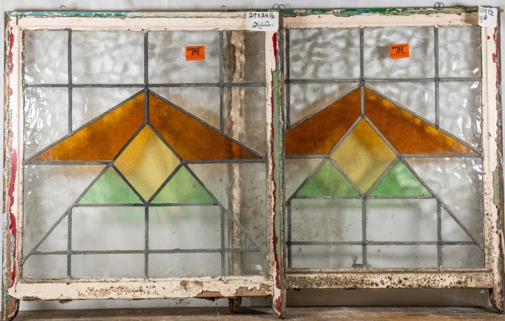 PAIR OF ENGLISH ART DECO STAINED GLASS PANELS: Pair of English Art Deco stained glass panels with amber, yellow, and green triangular motifs. Approximate dimensions: h. 29.5", w. 29" Disclaimer: This is an online court ordered bankruptcy sale. Par