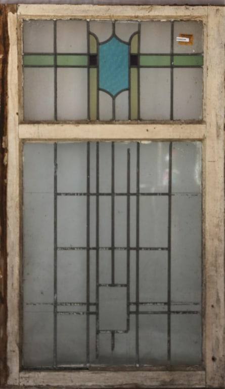 IRISH ART DECO STAINED GLASS PANEL: Irish Art Deco stained glass panel with a blue, purple, and yellow geometric medallion. Approximate dimensions: h. 54.5", w. 33" Disclaimer: This is an online court ordered bankruptcy sale. Participat