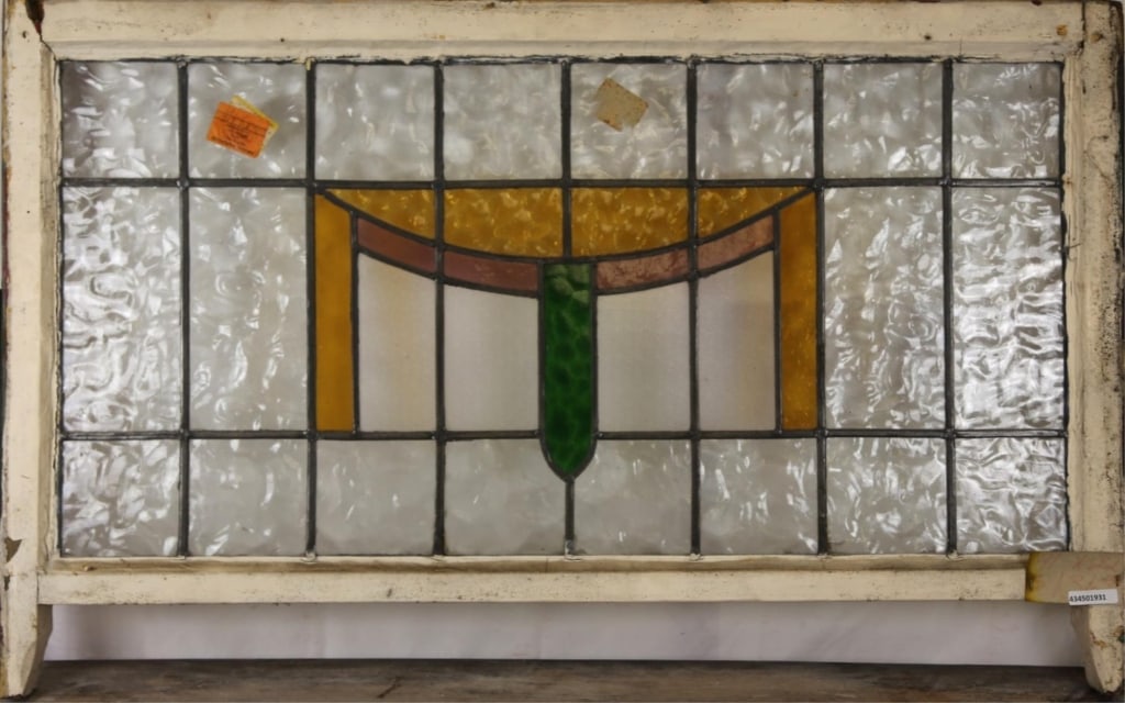 ENGLISH ART DECO STAINED GLASS PANEL: English Art Deco stained glass panel with purple, green, and amber geometric stained glass elements. Approximate dimensions: h. 31", w. 42" Disclaimer: This is an online court ordered bankruptcy sale.