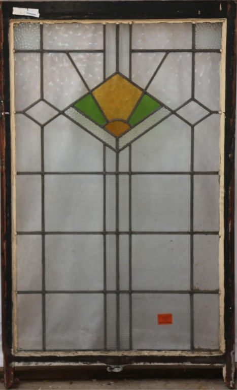 ENGLISH ART DECO STAINED GLASS PANEL: English Art Deco stained glass panel with a geometric amber and green medallion, some colorless leaded glass panels are textured. Approximate dimensions: h. 54", w. 33" Disclaimer: This is an online c