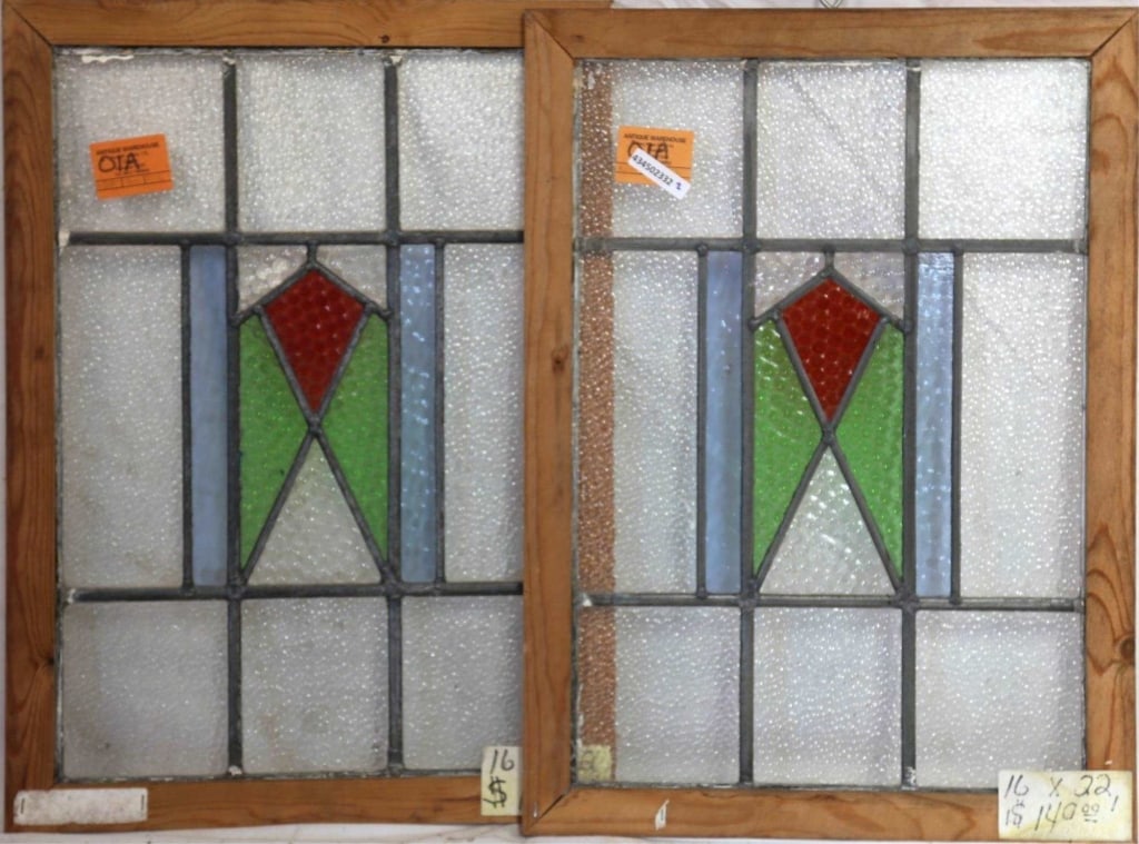 PAIR OF IRISH ART DECO STAINED GLASS PANELS: Pair of Irish Art Deco stained glass panels with multicolored geometric medallions in blue, red, and green. Approximate dimensions: h. 22", w. 16" Disclaimer: This is an online court ordered bankruptc