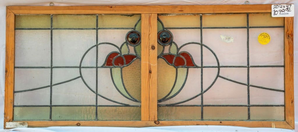 FRENCH ART NOUVEAU JEWELED STAINED GLASS PANEL: French Art Nouveau jeweled stained glass panel with a floral motif and two amber jeweled accents. Approximate dimensions: h. 20.5", d. 47" Disclaimer: This is an online court ordered bankruptcy sale.