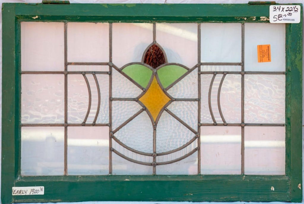 ENGLISH STAINED GLASS PANEL: English stained glass panel with a geometric medallion. Approximate dimensions: h. 22.5", w. 34" Disclaimer: This is an online court ordered bankruptcy sale. Participating bidders must have a credit c