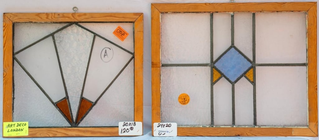 TWO ENGLISH ART DECO STAINED GLASS PANELS: Two English Art Deco stained glass panels with colorless textured leaded glass panels accented with red, amber, and purple geometric motifs. Approximate dimensions: h. 20", w. 24" Disclaimer: This is