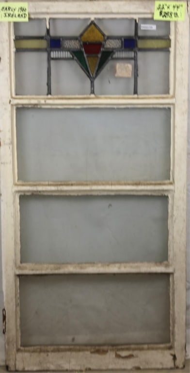 IRISH ART DECO STAINED GLASS PANEL: Irish Art Deco stained glass panel. Approximate dimensions: h. 44", w. 22" Disclaimer: This is an online court ordered bankruptcy sale. Participating bidders must have a credit card on file with Live
