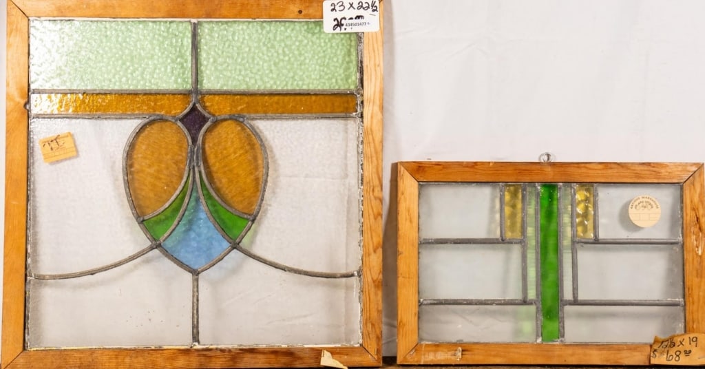 TWO CONTINENTAL STAINED GLASS PANELS: Two Continental stained glass panels with multicolored glass accents. Approximate dimensions: h. 23", w. 22.5" Disclaimer: This is an online court ordered bankruptcy sale. Participating bidders must h